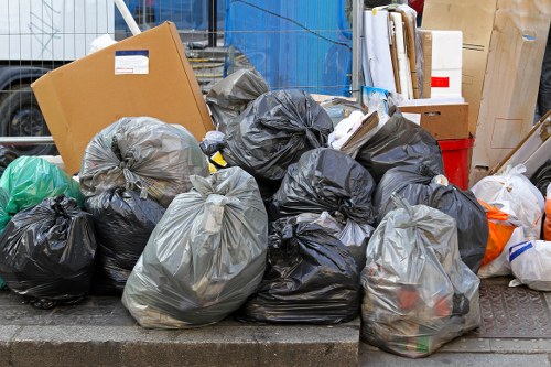 Workers loading debris into a skip